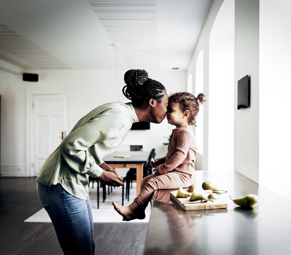 A parent and toddler sharing a tender, calm moment at home