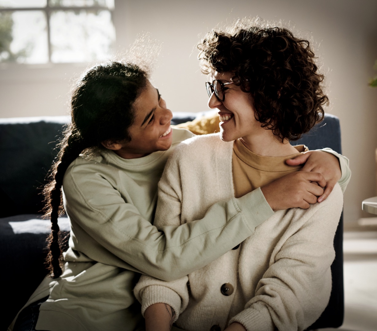 A parent and child sharing a warm, reassuring embrace at home
